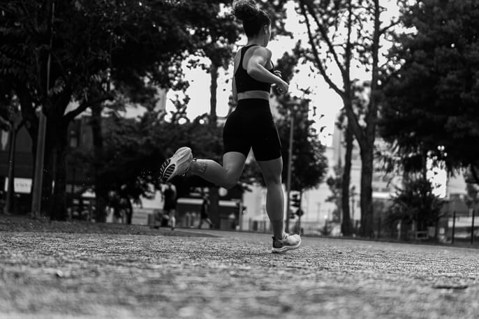 Runner mid-stride on a tree-lined path