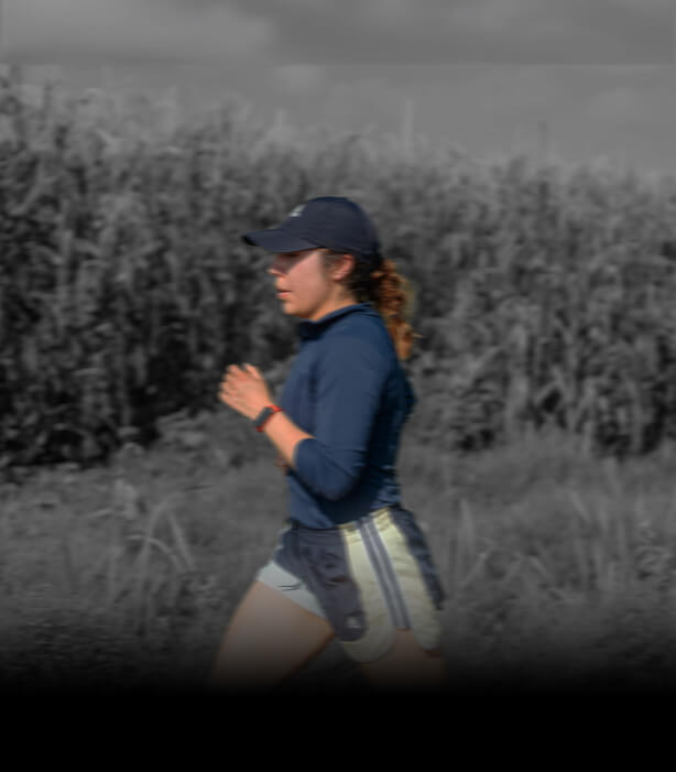 Runner training outdoors in a navy cap