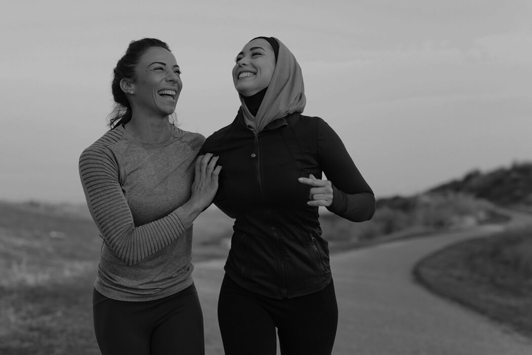 Two runners laughing together after training
